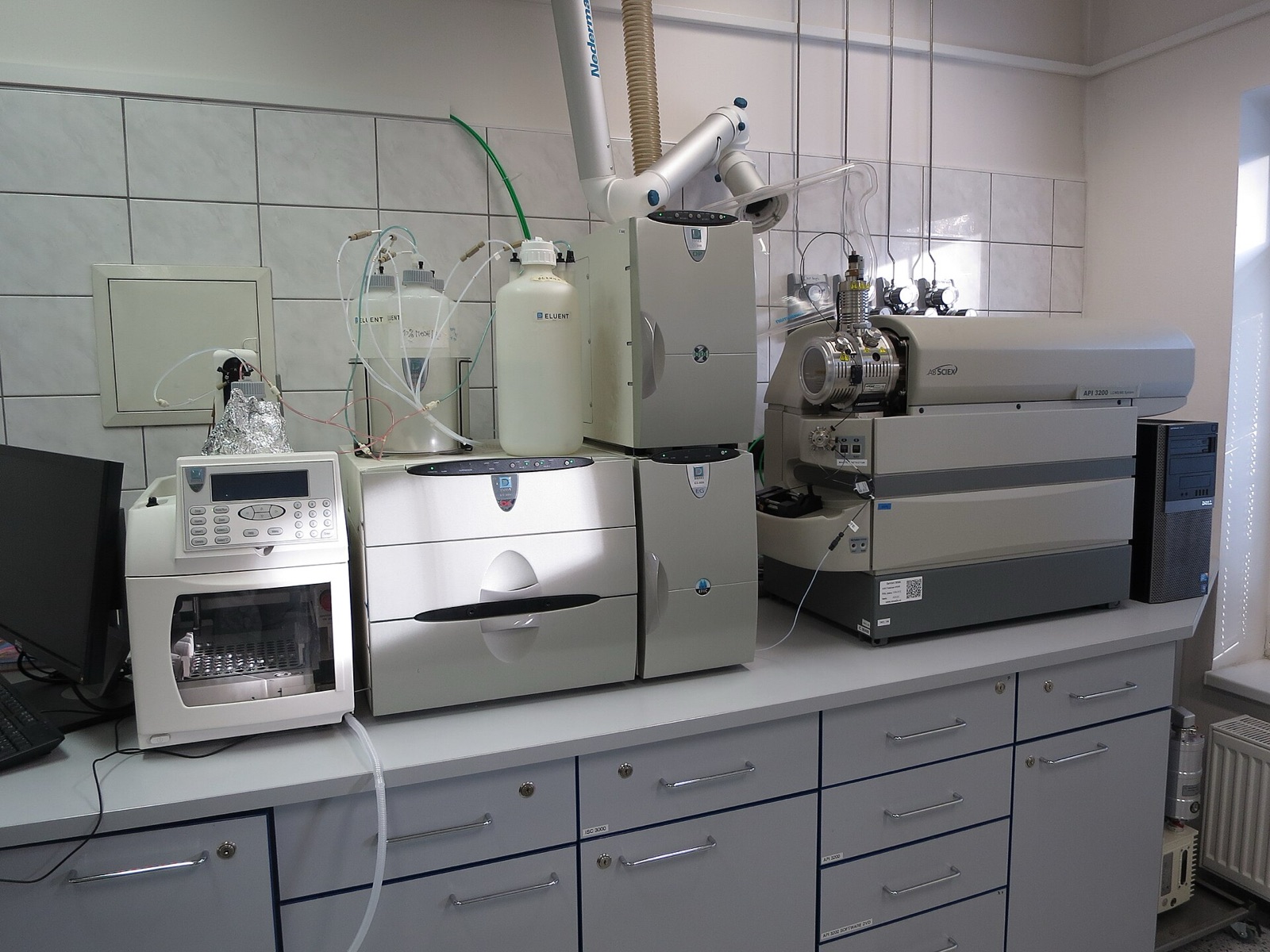 Chromatography system with autosampler and mass spectrometer on a lab bench